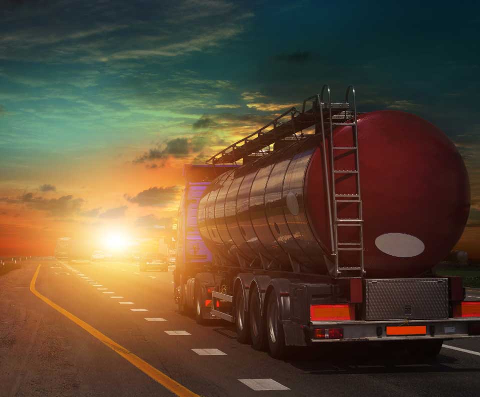 Oil truck driving into the sunset